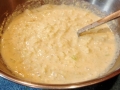 Prepared Batter with Chopped Onions with a ladle.